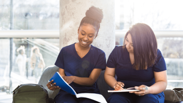 Students in care uniforms seated smiling in the sun